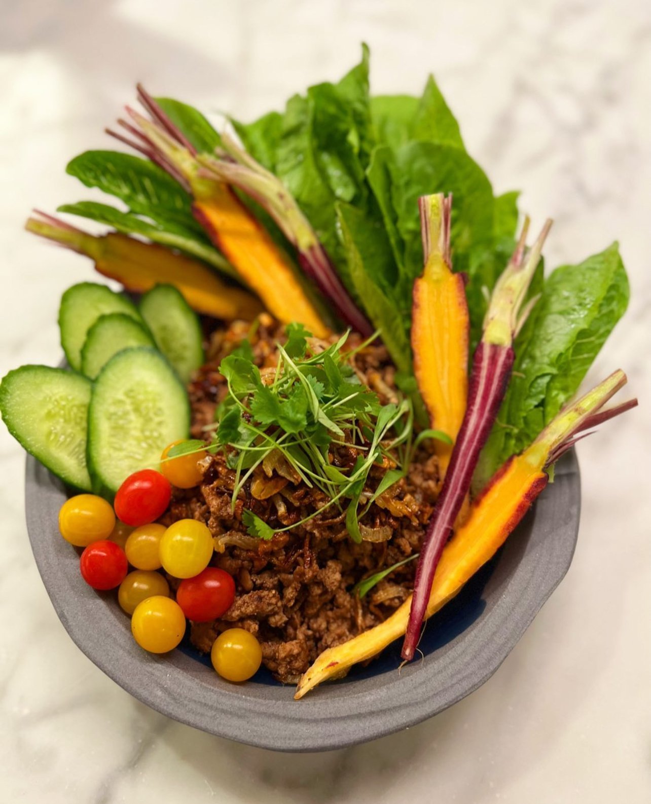 Laab Seasoned Beff with Cucumber, cherry tomatoes, carrots.